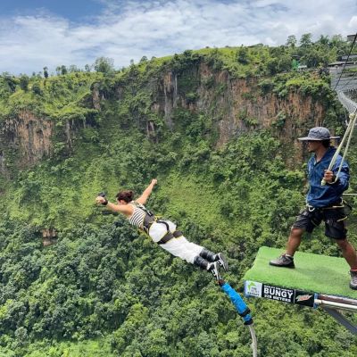 Bungee jumper diving off the Kushma bungee jump platform above the Kali Gandaki Gorge, Nepal