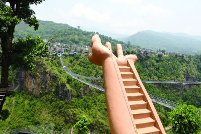 Bungee jumper diving off the Kushma bungee jump platform above the Kali Gandaki Gorge, Nepal