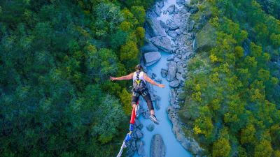Bungee jumper diving off the cantilever bridge over the Seti Gorge in Pokhara, Nepal
