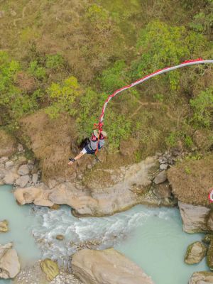 Bungee jumper diving off the cantilever bridge over the Seti Gorge in Pokhara, Nepal
